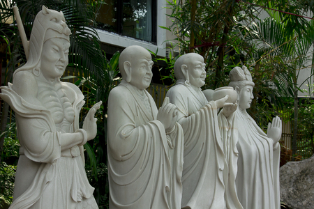 Statue of Chinese priest carved from white marble.の写真素材