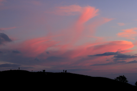 Silhouettes of people standing on the summit.の写真素材