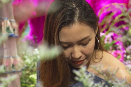 Portrait of a beautiful woman with a flower archの写真素材