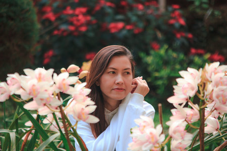 Women are watching the pink orchid in nature.の写真素材