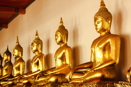 Beautiful golden Buddha On the pedestal, some white wallsの写真素材