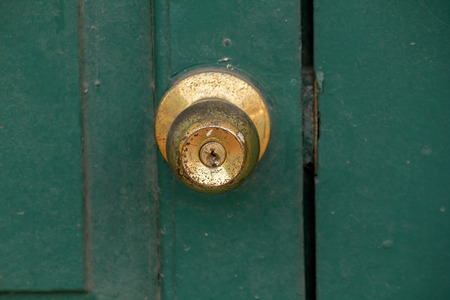 Old brass knobs on the green door Used to close or open the doorの写真素材