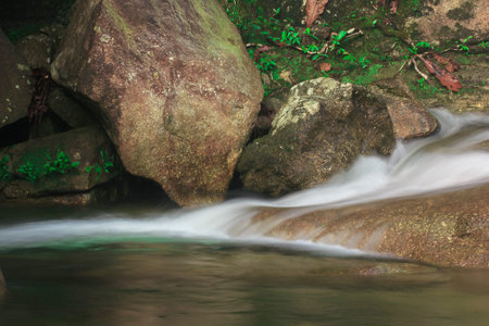 Waterfalls flow through rocks in nature. of Phatthalung Province, Thailand.