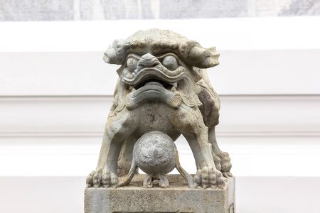 Chinese style lion carved stone on the pedestal is a sacred animal of Chinese belief.の写真素材