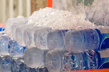 The ice cubes are on a bottle of water to cool.の写真素材