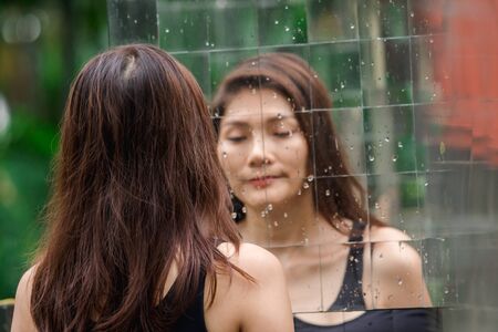 The shadow of a woman is in the mirror.の写真素材