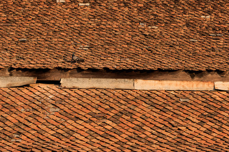 Old clay tiles on the roof of the Thai temple