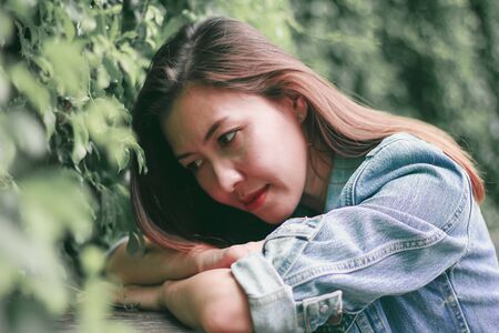 Woman lying down at the table in the parkの写真素材