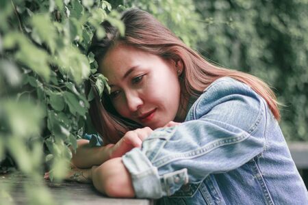 Woman lying down at the table in the parkの写真素材