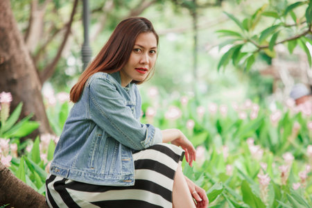 woman sitting under a tree in the park