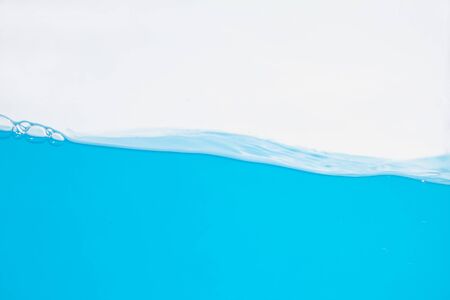 Water splash. Aqua flowing in waves and bubbles . on white background.の写真素材