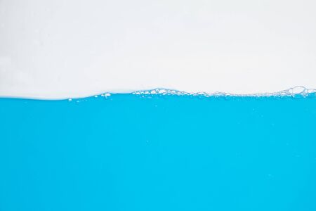 Water splash. Aqua flowing in waves and bubbles . on white background.の写真素材