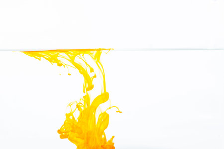 Orange ink drop in water, abstract orange ink in water on white background
