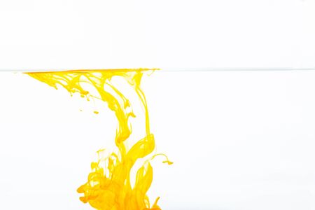 Orange ink drop in water, abstract orange ink in water on white backgroundの写真素材