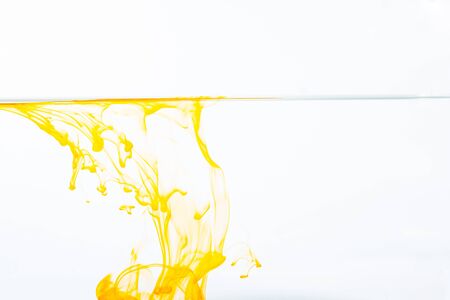 Orange ink drop in water, abstract orange ink in water on white backgroundの写真素材
