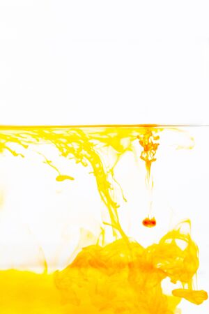 Orange ink drop in water, abstract orange ink in water on white backgroundの写真素材
