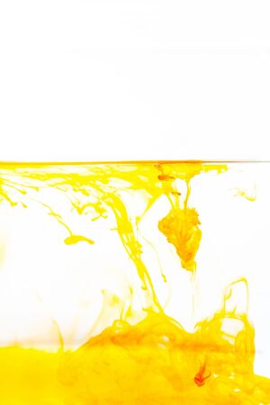 Orange ink drop in water, abstract orange ink in water on white backgroundの写真素材