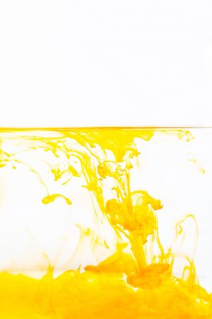 Orange ink drop in water, abstract orange ink in water on white backgroundの写真素材