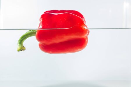 Sweet pepper in water splashes, red sweet pepper on a white background. Sweet peppers are a type of pepper. Not spicyの写真素材