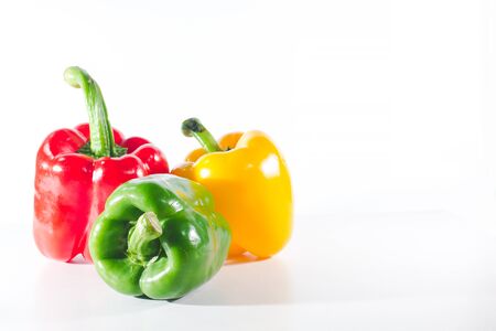 Sweet peppers are on a white background, sweet peppers are used for cooking and to be eaten fresh, sweet peppers are non-spicy peppers.の写真素材