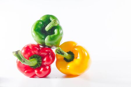 Sweet peppers are on a white background, sweet peppers are used for cooking and to be eaten fresh, sweet peppers are non-spicy peppers.の写真素材