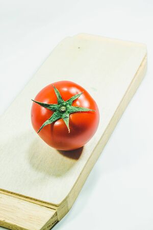 Red tomatoes on the White Background, Tomatoes are eaten when ripe, red Or fully ripe orangeの写真素材