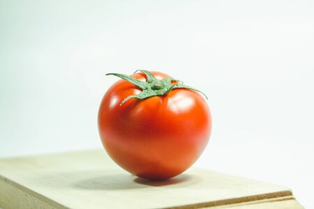 Red tomatoes on the White Background, Tomatoes are eaten when ripe, red Or fully ripe orangeの写真素材