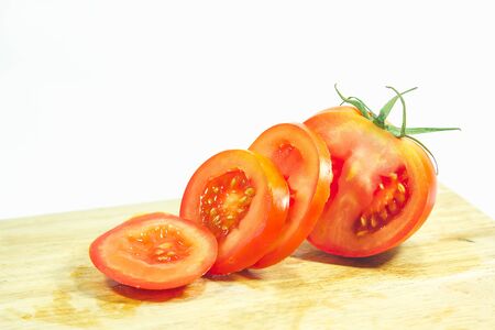 Red tomatoes on wood, red tomatoes being cut.
Tomatoes are eaten when ripe, ripe, red Or fully ripe orangeの写真素材