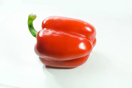 Red bell peppers on a white background, Sweet peppers used for cooking and to be eaten fresh, Sweet peppers are peppers that are not spicの写真素材