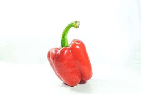 Red bell peppers on a white background, Sweet peppers used for cooking and to be eaten fresh, Sweet peppers are peppers that are not spicの写真素材