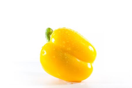 Yellow bell peppers on a white background, Sweet peppers used for cooking and to be eaten fresh, Sweet peppers are peppers that are not spicyの写真素材
