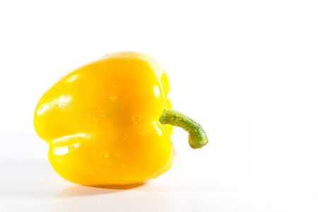 Yellow bell peppers on a white background, Sweet peppers used for cooking and to be eaten fresh, Sweet peppers are peppers that are not spicyの写真素材