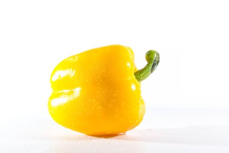 Yellow bell peppers on a white background, Sweet peppers used for cooking and to be eaten fresh, Sweet peppers are peppers that are not spicyの写真素材