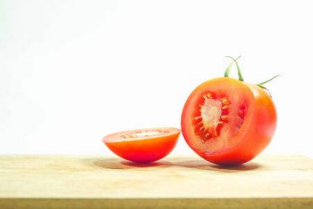 Red tomatoes on wood, red tomatoes being cut.
Tomatoes are eaten when ripe, ripe, red Or fully ripe orangeの写真素材