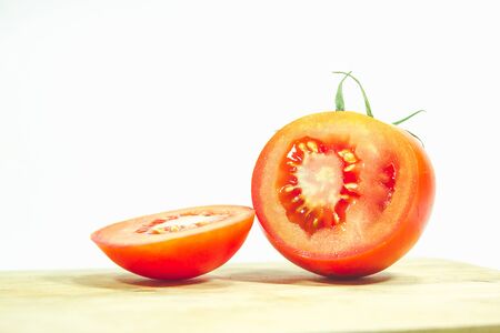 Red tomatoes on wood, red tomatoes being cut.
Tomatoes are eaten when ripe, ripe, red Or fully ripe orangeの写真素材