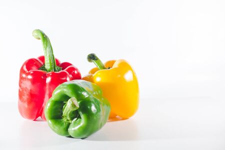 Sweet peppers are on a white background, sweet peppers are used for cooking and to be eaten fresh, sweet peppers are non-spicy peppers.の写真素材
