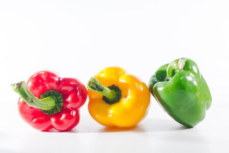 Sweet peppers are on a white background, sweet peppers are used for cooking and to be eaten fresh, sweet peppers are non-spicy peppers.の写真素材