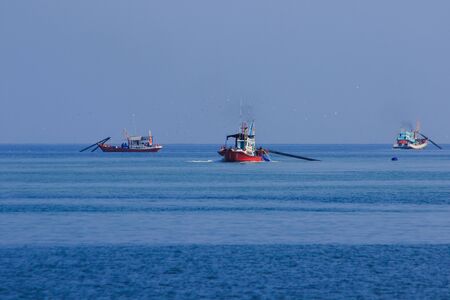 Thai fishing boat at sea , Thai fishing boats searching for fish in the sea And have equipment for catching fishの写真素材