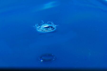 Water droplets, Blue water drops splashes. Drop water close-up, Blue water drop macroの写真素材