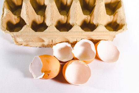 Broken egg isolated on white background, broken egg shell from impact