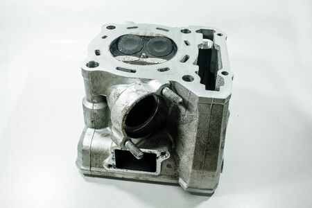 Old motorcycle spare parts on a white background. Motorcycle parts that are damagedの写真素材