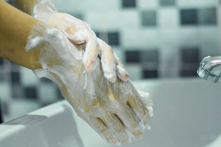 Wash your hands with soap to prevent covid 19, wash your hands to prevent epidemics.の写真素材