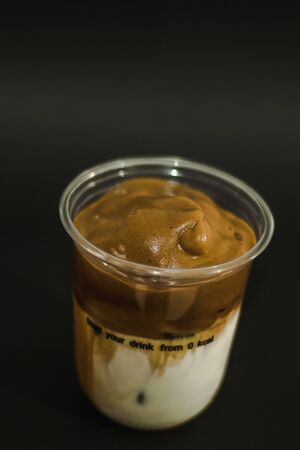 Ice latte coffee in a plastic mug On a black backgroundの写真素材