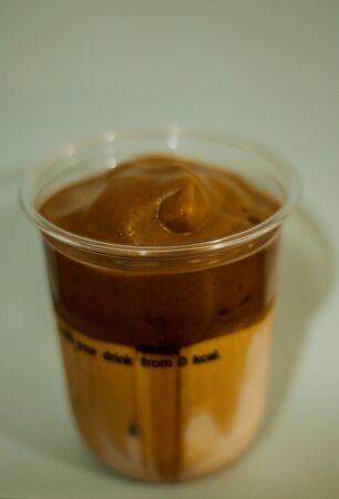 Ice latte coffee in a plastic mug , Coffee cream in a glassの写真素材