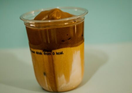 Ice latte coffee in a plastic mug , Coffee cream in a glassの写真素材