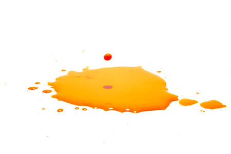 Orange water droplets splashing on a white backgroundの写真素材