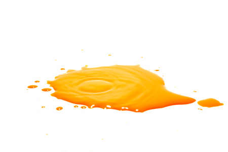 Orange water droplets splashing on a white backgroundの写真素材