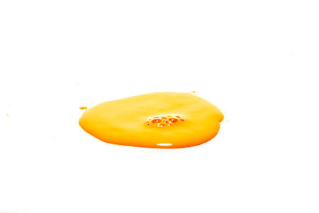 Orange water droplets splashing on a white backgroundの写真素材