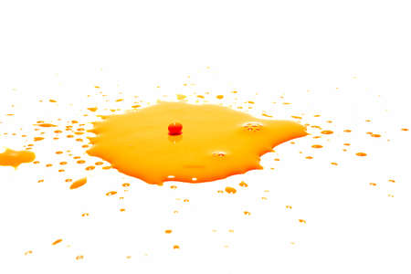 Orange water droplets splashing on a white backgroundの写真素材