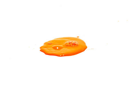 Orange water droplets splashing on a white backgroundの写真素材